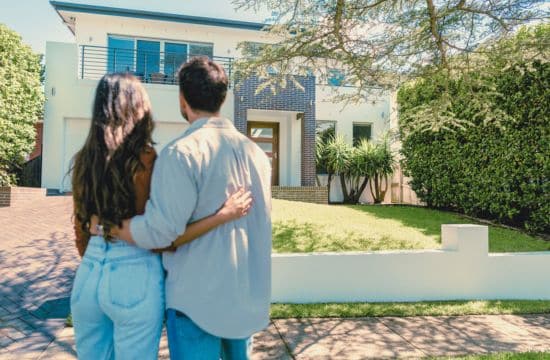 couple standing in front of their next potential home